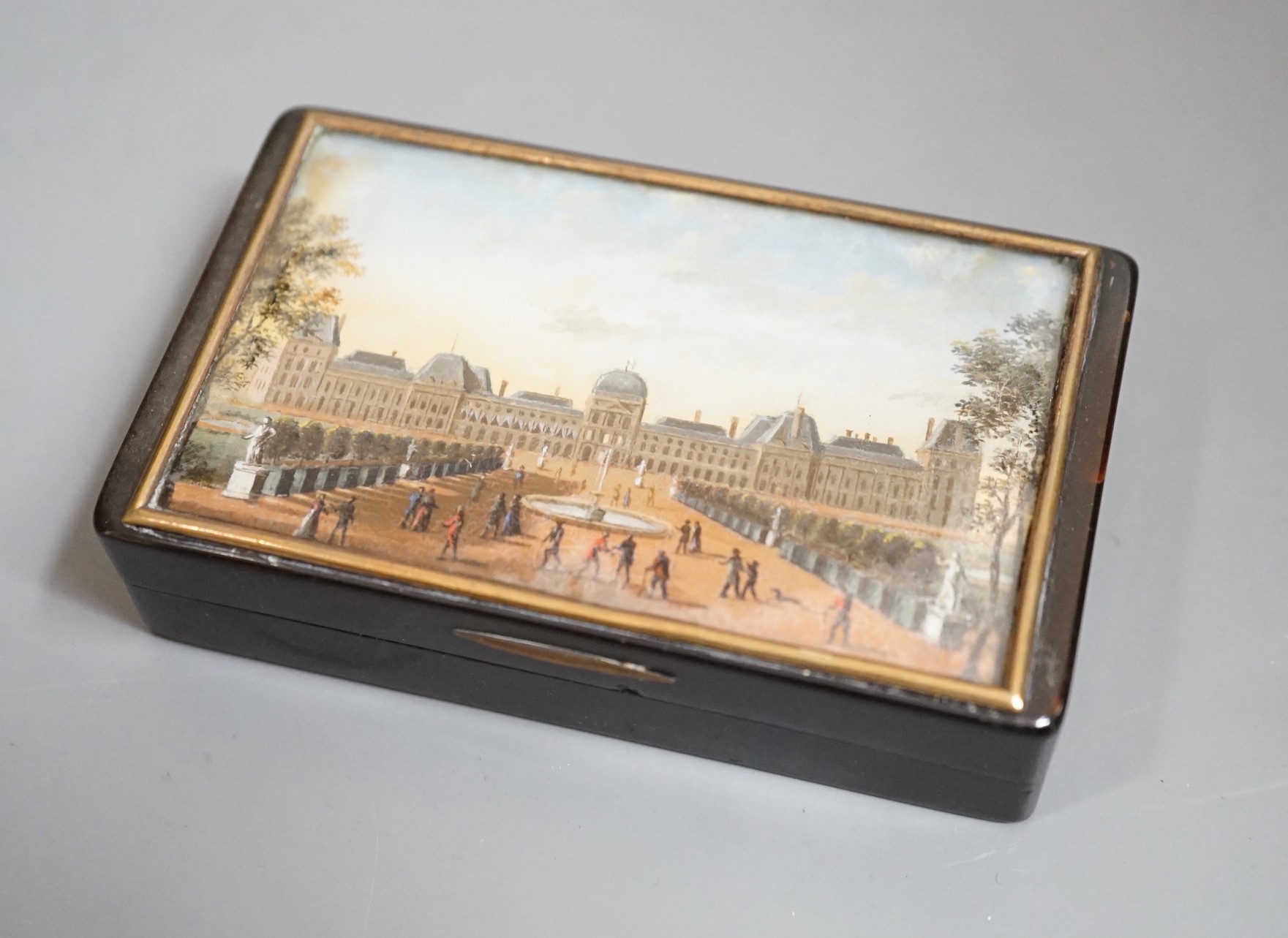 A 19th century French tortoiseshell snuff box, the top with reverse painted glass scene Tuileries Palace, Paris, J F Lebell, 9cms wide x 5.5cms